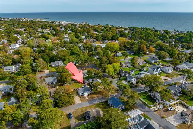 an aerial view of a house with a yard and lake view