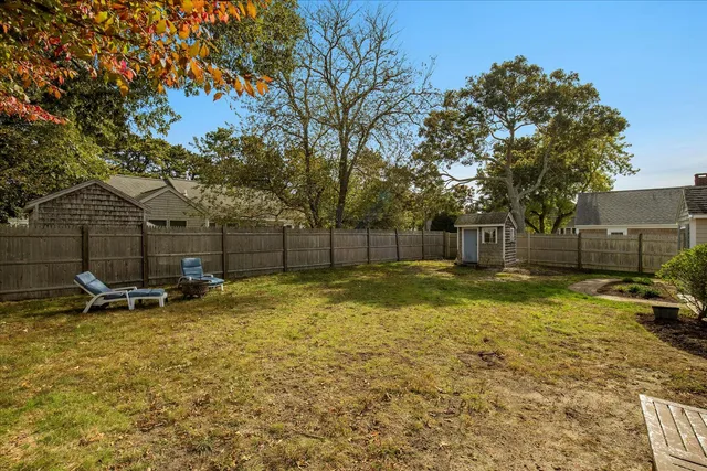 a backyard of a house with table and chairs