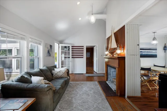 a living room with furniture a fireplace and a flat screen tv