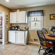 16 Point Road Toms River, NJ 08753 - Photo 22 of 25 a kitchen with stainless steel appliances granite countertop a stove a sink a dining table and chairs