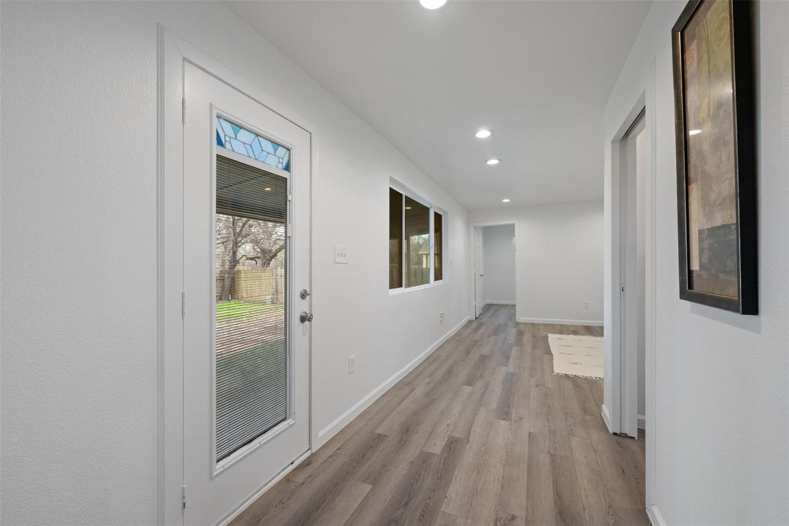 901 Valdez Street, Unit C Austin, TX 78741 - Photo 4 of 12 a view of hallway with a large window and wooden floor