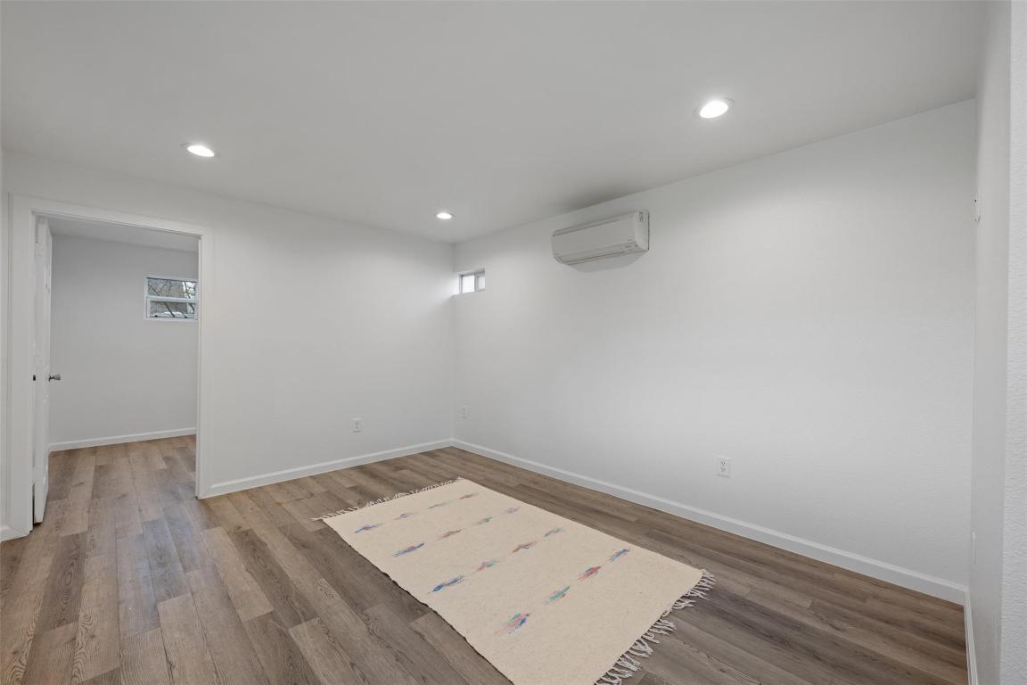 901 Valdez Street, Unit C Austin, TX 78741 - Photo 8 of 12 an empty room with wooden floor