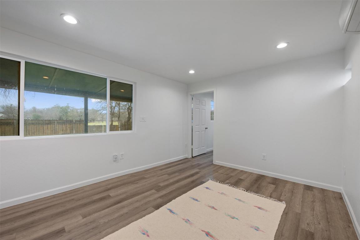 901 Valdez Street, Unit C Austin, TX 78741 - Photo 9 of 12 an empty room with wooden floor and windows
