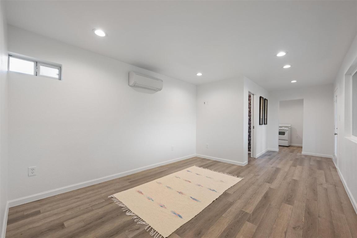 901 Valdez Street, Unit C Austin, TX 78741 - Photo 10 of 12 an empty room with wooden floor and windows