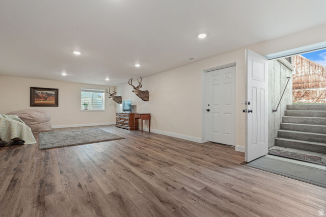 75 North 100th Street West Fillmore, UT 84631 - Photo 37 of 62 Family room with healthy amount of natural light, light wood finished floors, and stairway leading to back yard