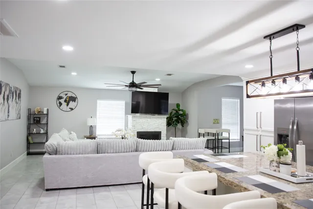 a living room with fireplace furniture and a flat screen tv