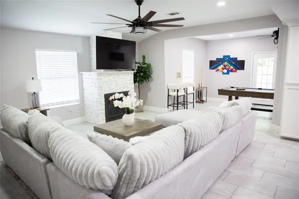 a living room with furniture and a mirror