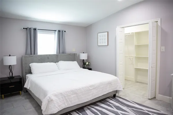 a bedroom with a bed and a window