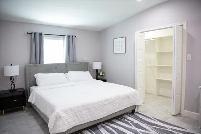 a bedroom with a bed and a window