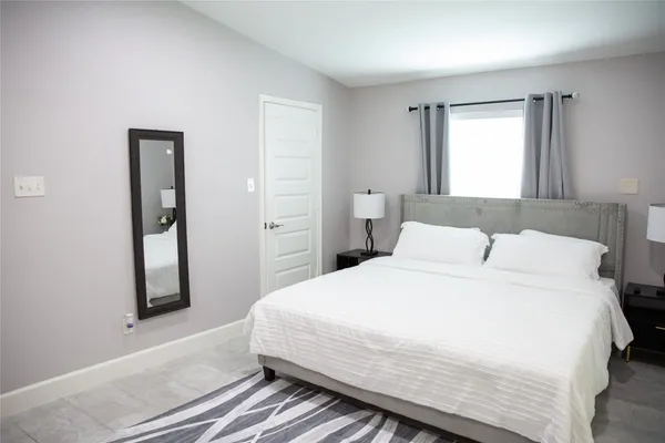 a bathroom with a granite countertop toilet sink and mirror