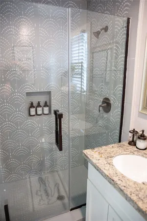 a bathroom with a toilet and a shower