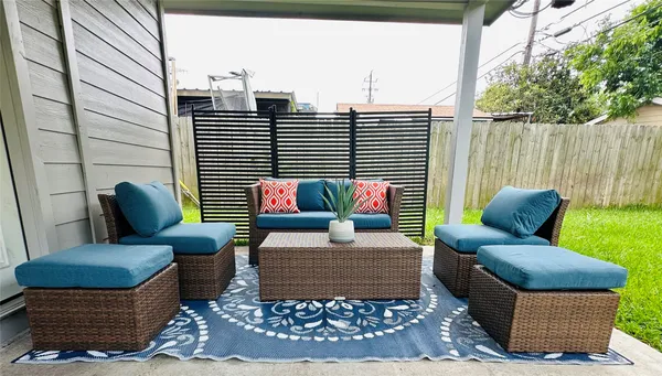 a view of a patio with couches and a potted plant on a table