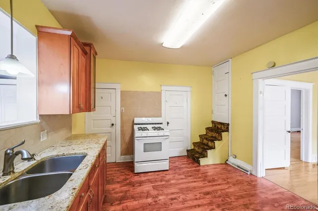 a kitchen with a refrigerator sink and cabinets