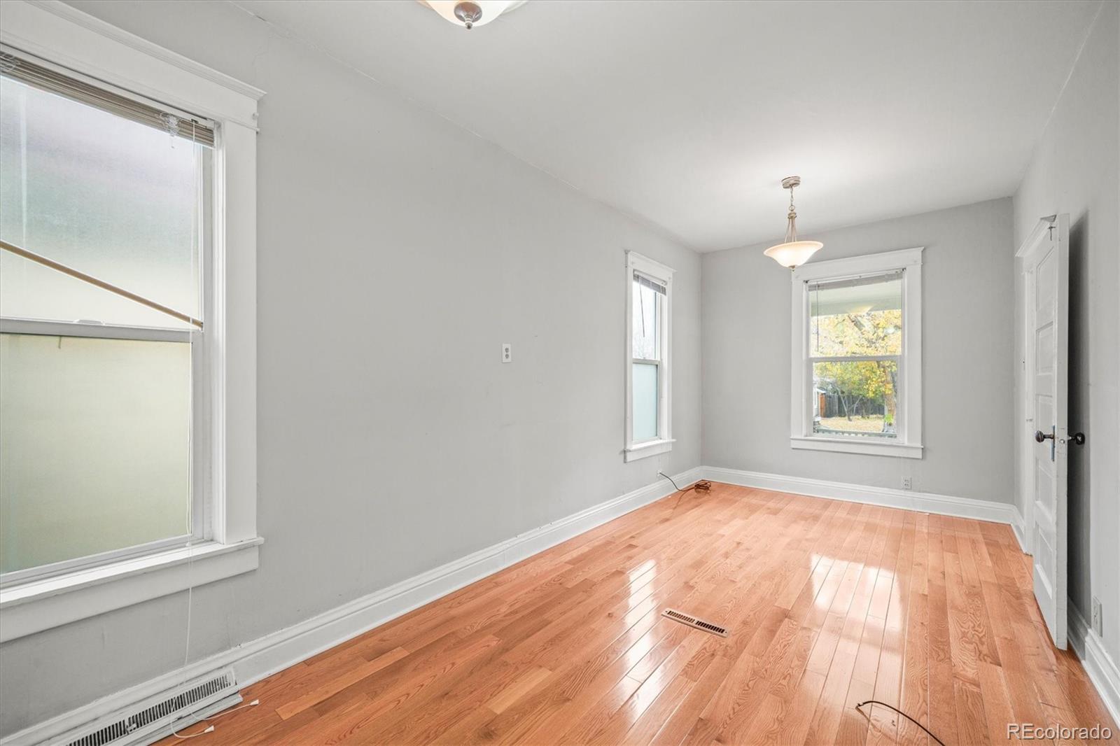 4551 Utica Street Denver, CO 80212 - Photo 14 of 32 an empty room with wooden floor and windows