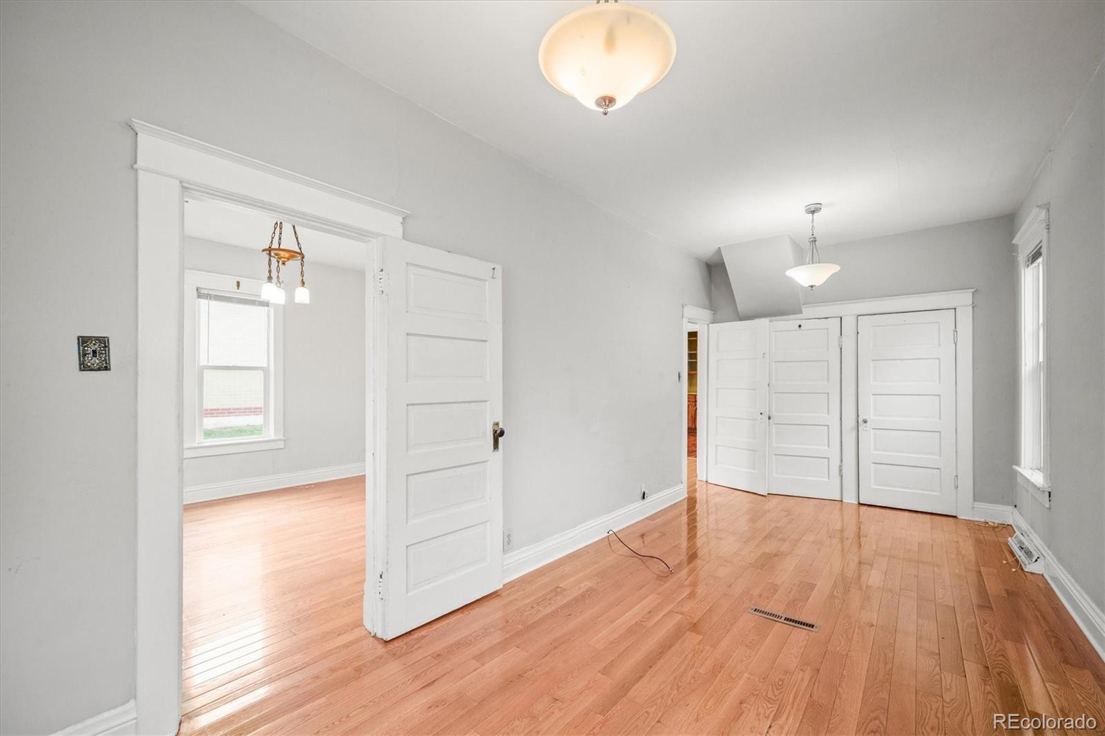 4551 Utica Street Denver, CO 80212 - Photo 17 of 32 wooden floor in an empty room with a window
