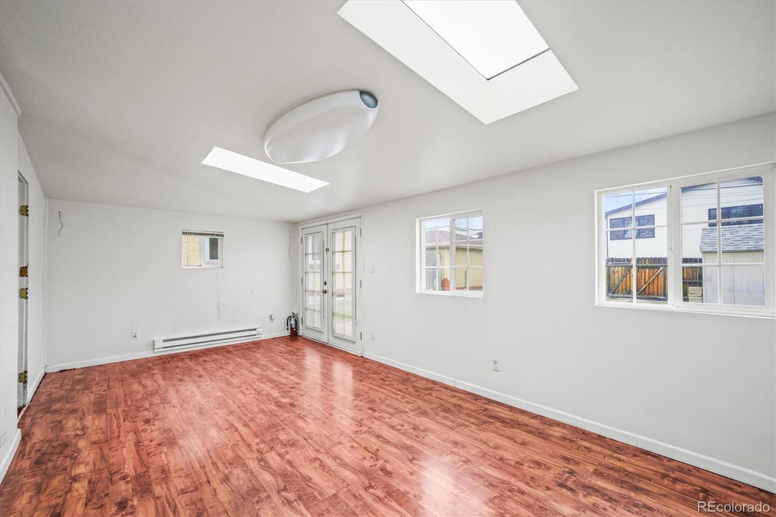4551 Utica Street Denver, CO 80212 - Photo 19 of 32 a view of empty room with wooden floor and fan