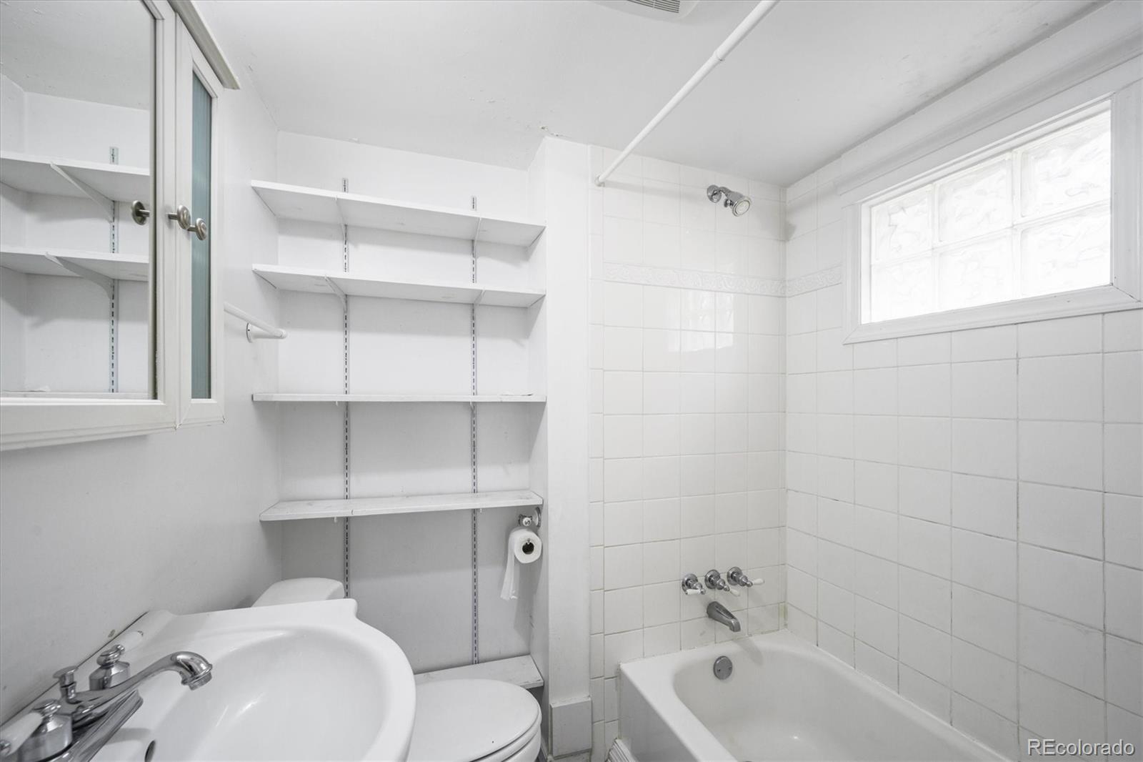 4551 Utica Street Denver, CO 80212 - Photo 20 of 32 a bathroom with a sink a toilet and bathtub