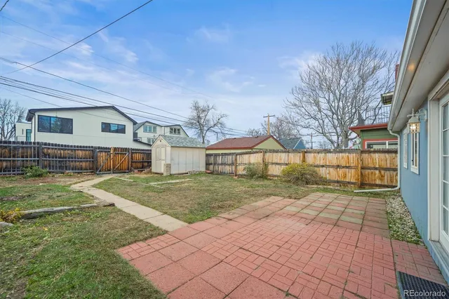 a view of a yard in front of a house with large trees