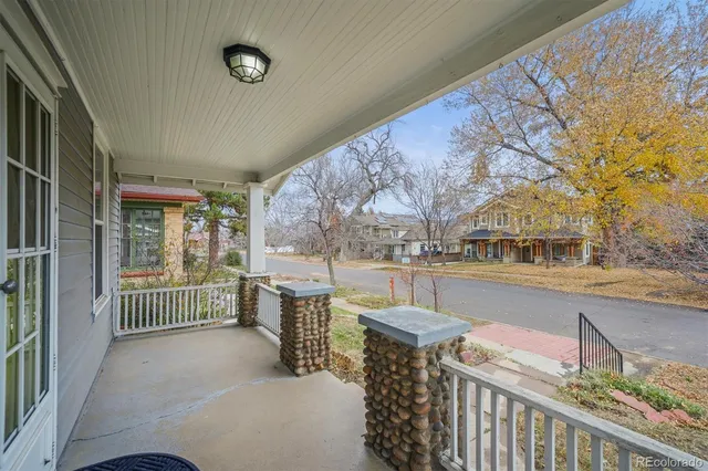 a view of a patio with couches and wooden fence