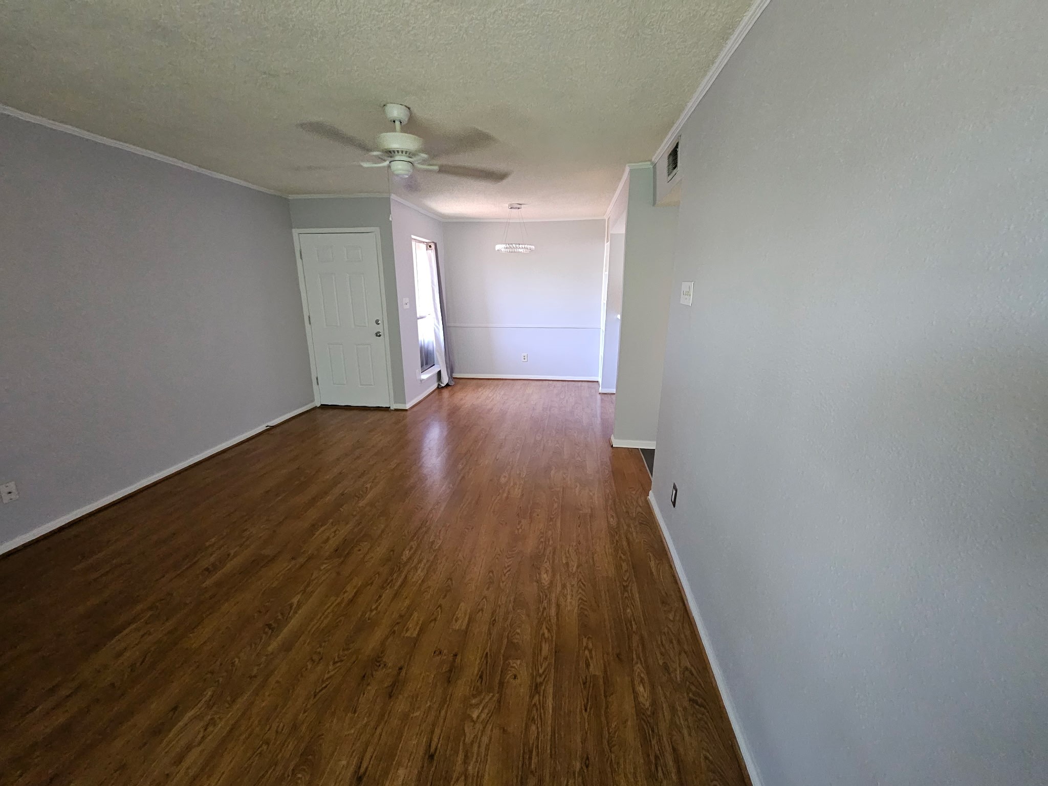 1505 Ward Road, Unit 112 Baytown, TX 77520 - Photo 9 of 15 an empty room with wooden floor and a ceiling fan