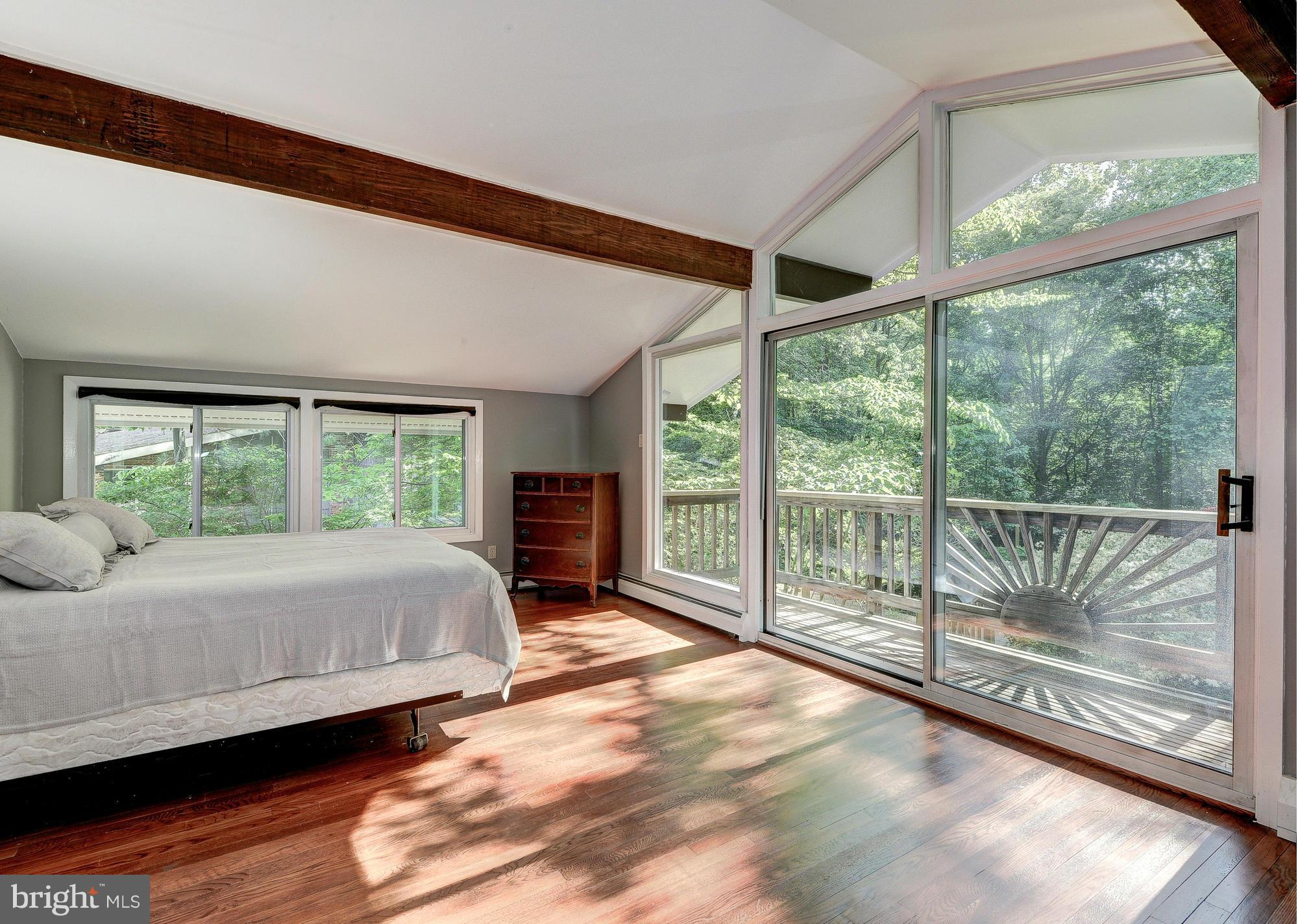 6718 Persimmon Tree Road Bethesda, MD 20817 - Photo 19 of 30 a bed sitting in a spacious bedroom next to a window