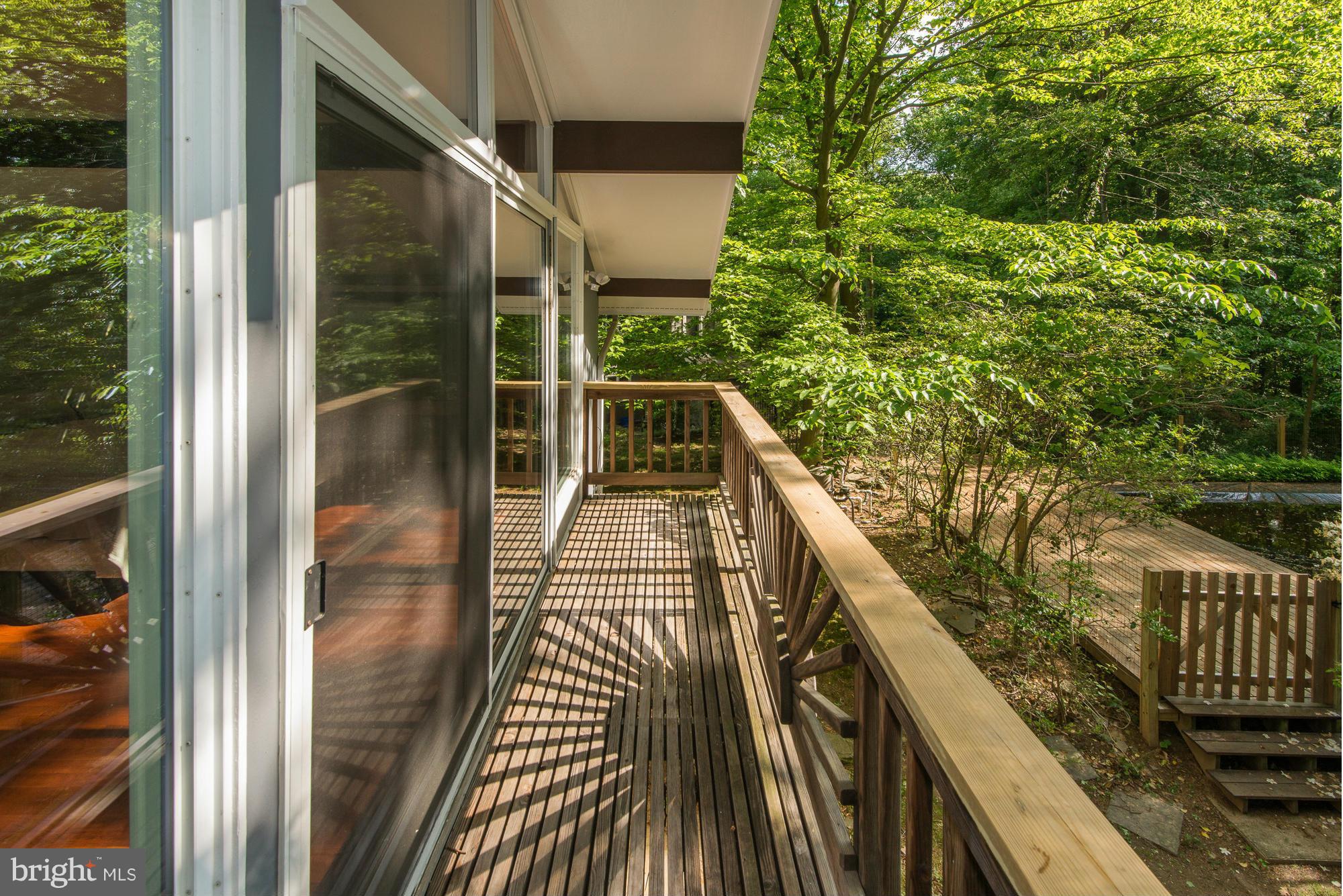 6718 Persimmon Tree Road Bethesda, MD 20817 - Photo 20 of 30 a balcony with view of wooden floor