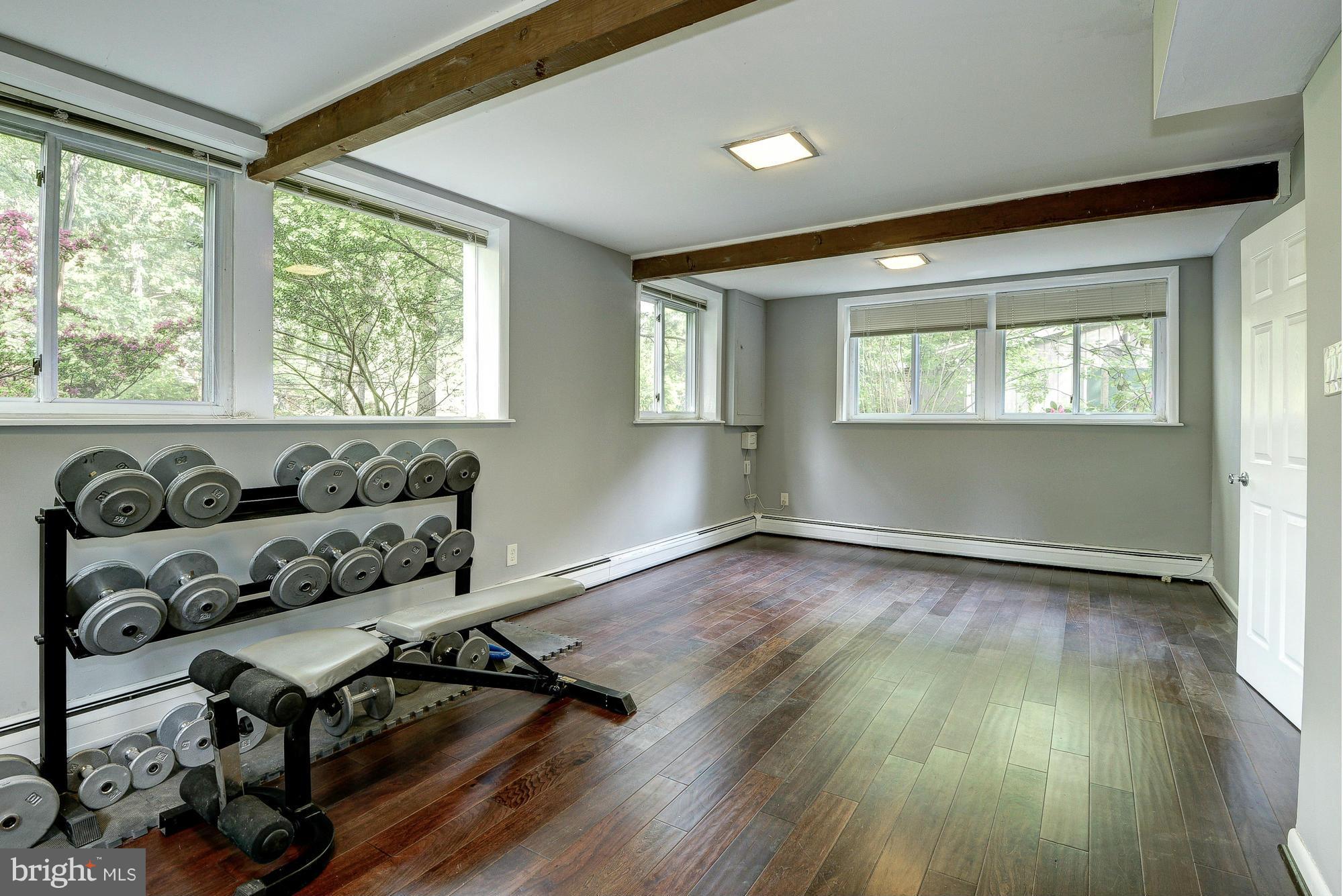 6718 Persimmon Tree Road Bethesda, MD 20817 - Photo 23 of 30 a view of a room with wooden floor and a window