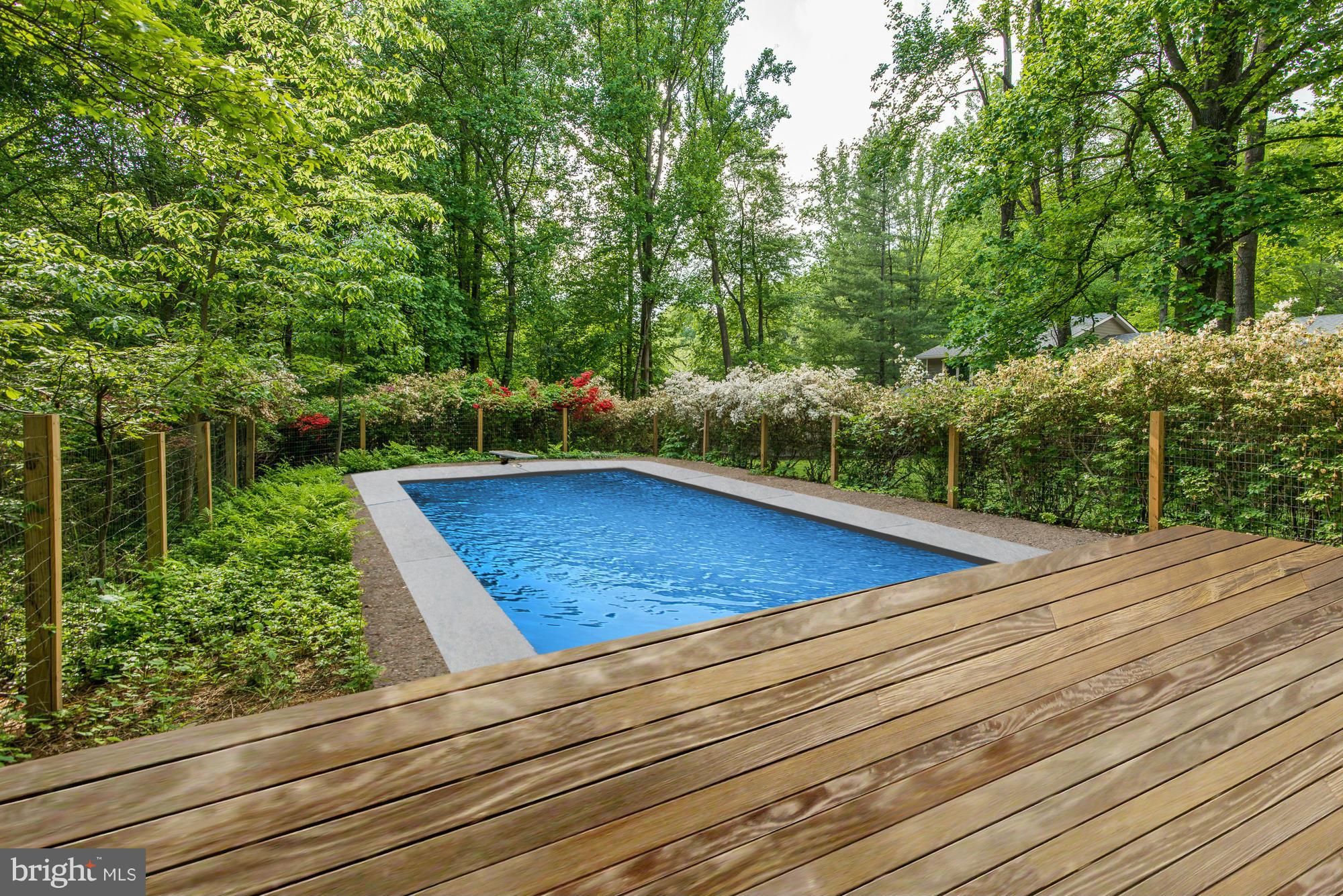 6718 Persimmon Tree Road Bethesda, MD 20817 - Photo 29 of 30 a view of a tennis ground with large trees