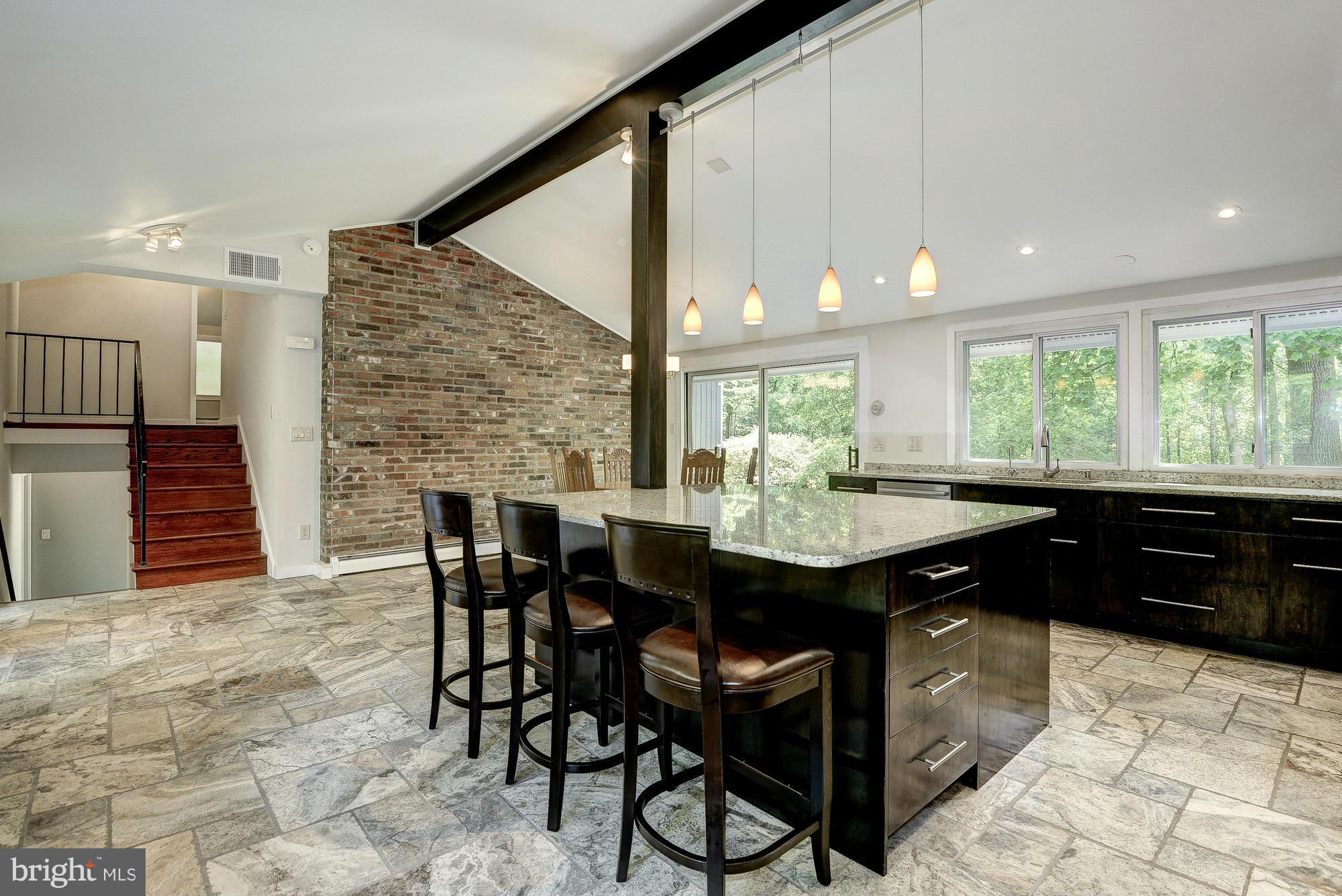 6718 Persimmon Tree Road Bethesda, MD 20817 - Photo 6 of 30 a kitchen with a table and chairs in it