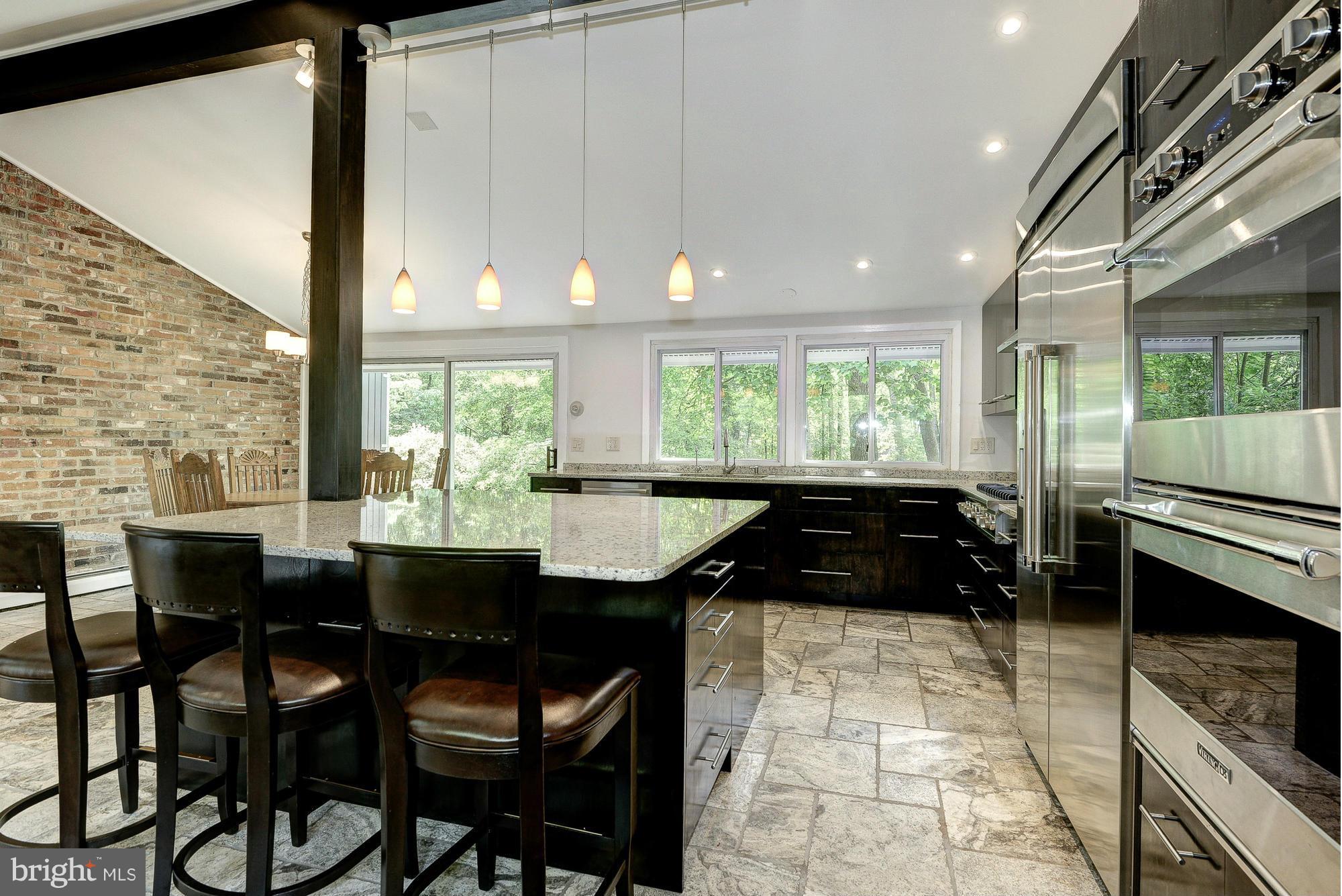 6718 Persimmon Tree Road Bethesda, MD 20817 - Photo 7 of 30 a kitchen with a table chairs and stove