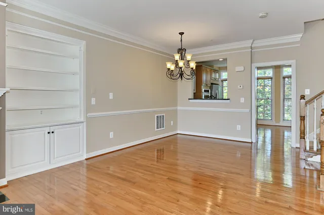 a kitchen with stainless steel appliances granite countertop a stove a sink dishwasher and a refrigerator with wooden floor