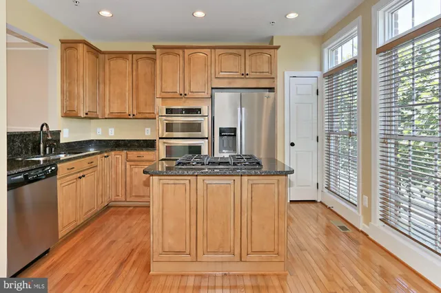a view of a room with wooden floor and a window