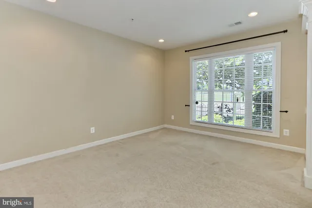 a view of a livingroom with wooden floor and a fireplace