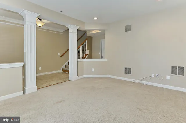 a view of empty room with wooden floor and fireplace