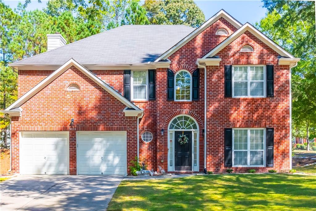 640 Fitzgerald Place Atlanta, GA 30349 - Photo 1 of 46 a front view of house with yard