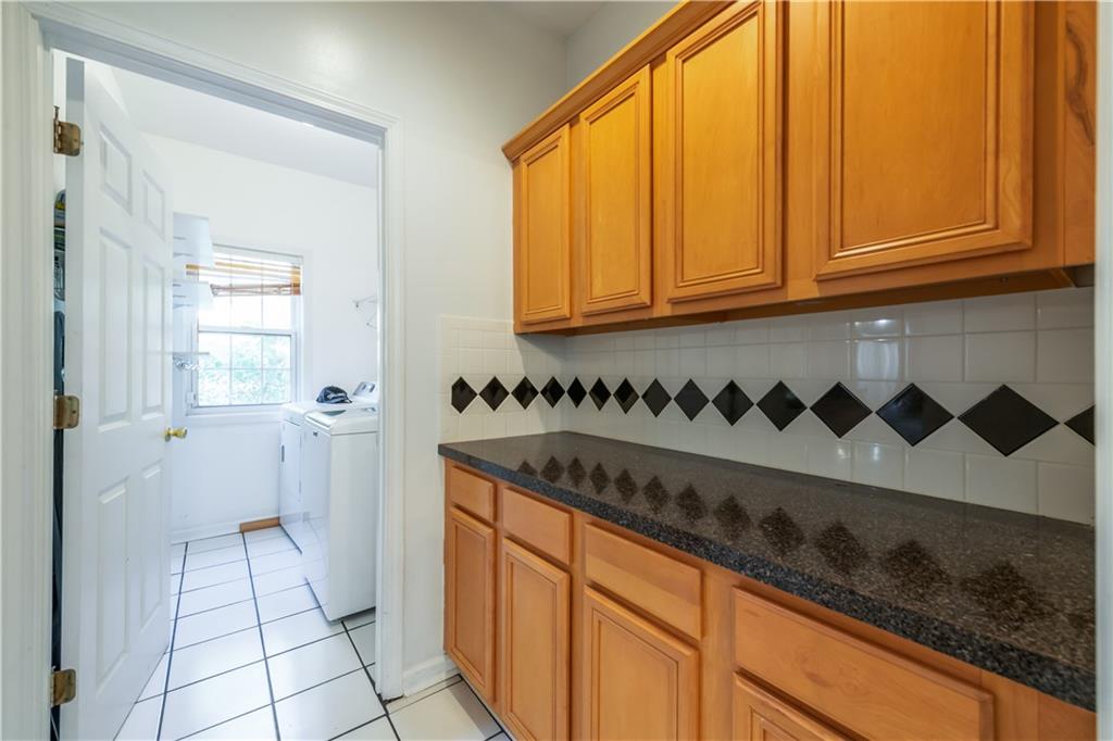 640 Fitzgerald Place Atlanta, GA 30349 - Photo 21 of 46 a kitchen with a sink and cabinets
