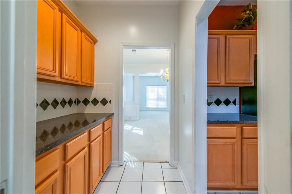 640 Fitzgerald Place Atlanta, GA 30349 - Photo 22 of 46 a kitchen with stainless steel appliances granite countertop a stove and a refrigerator