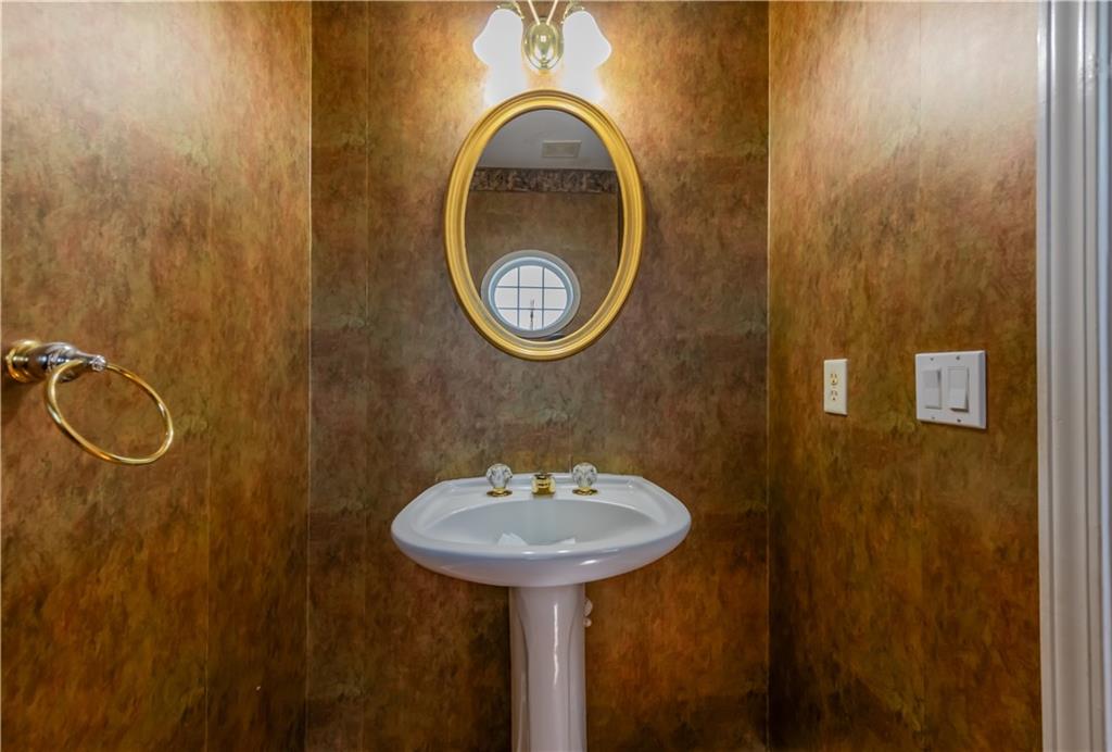 640 Fitzgerald Place Atlanta, GA 30349 - Photo 25 of 46 a bathroom with a sink and a mirror