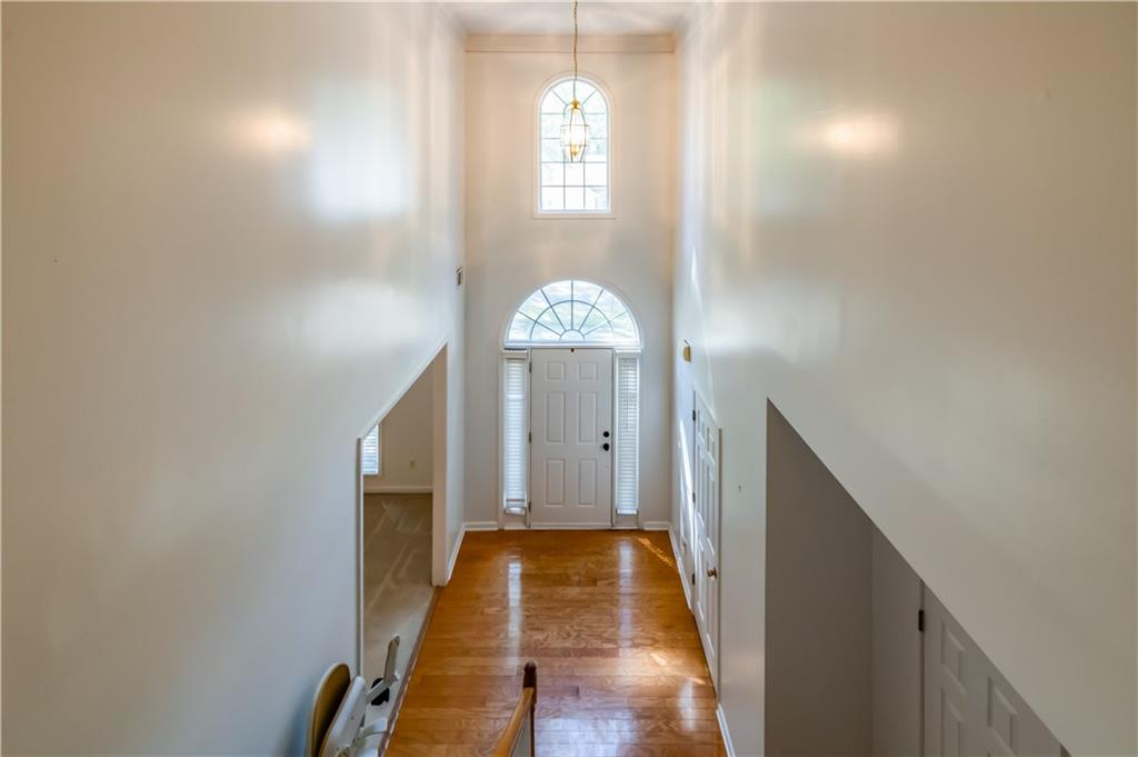 640 Fitzgerald Place Atlanta, GA 30349 - Photo 27 of 46 a view of a hallway with entryway wooden floor and front door