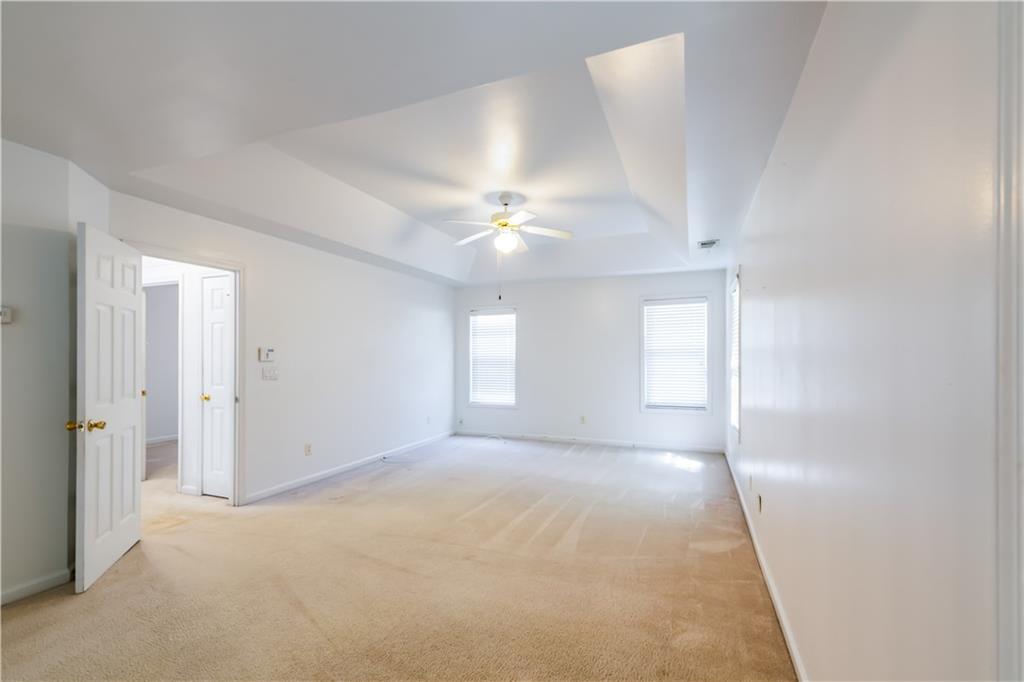 640 Fitzgerald Place Atlanta, GA 30349 - Photo 28 of 46 an empty room with windows and ceiling fan