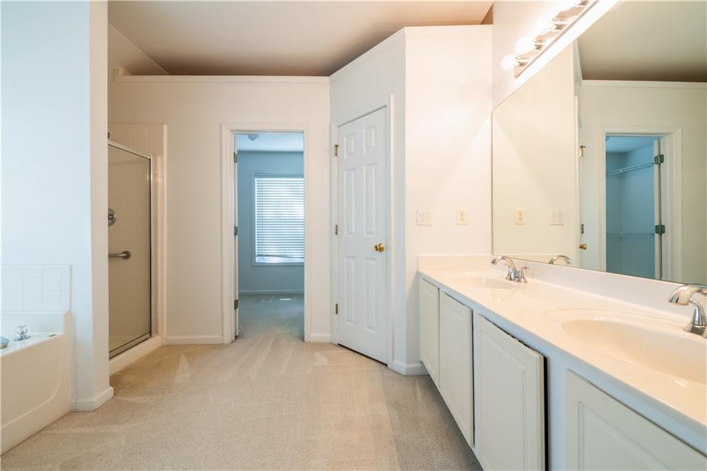 640 Fitzgerald Place Atlanta, GA 30349 - Photo 30 of 46 a bathroom with a sink and a mirror