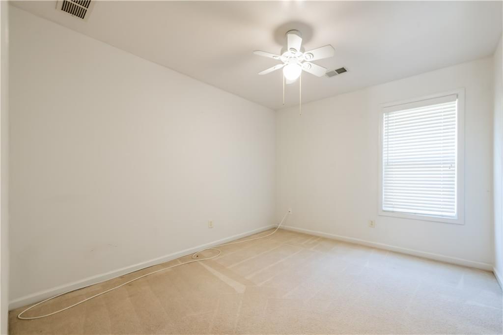 640 Fitzgerald Place Atlanta, GA 30349 - Photo 33 of 46 an empty room with a chandelier fan and windows