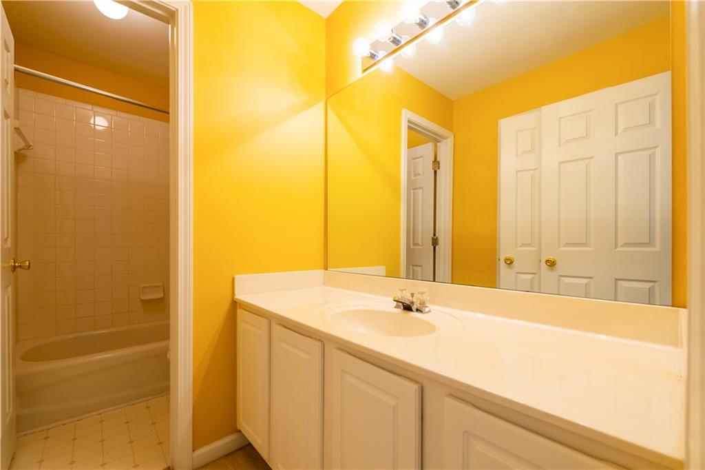 640 Fitzgerald Place Atlanta, GA 30349 - Photo 35 of 46 a bathroom with a granite countertop sink and a bathtub