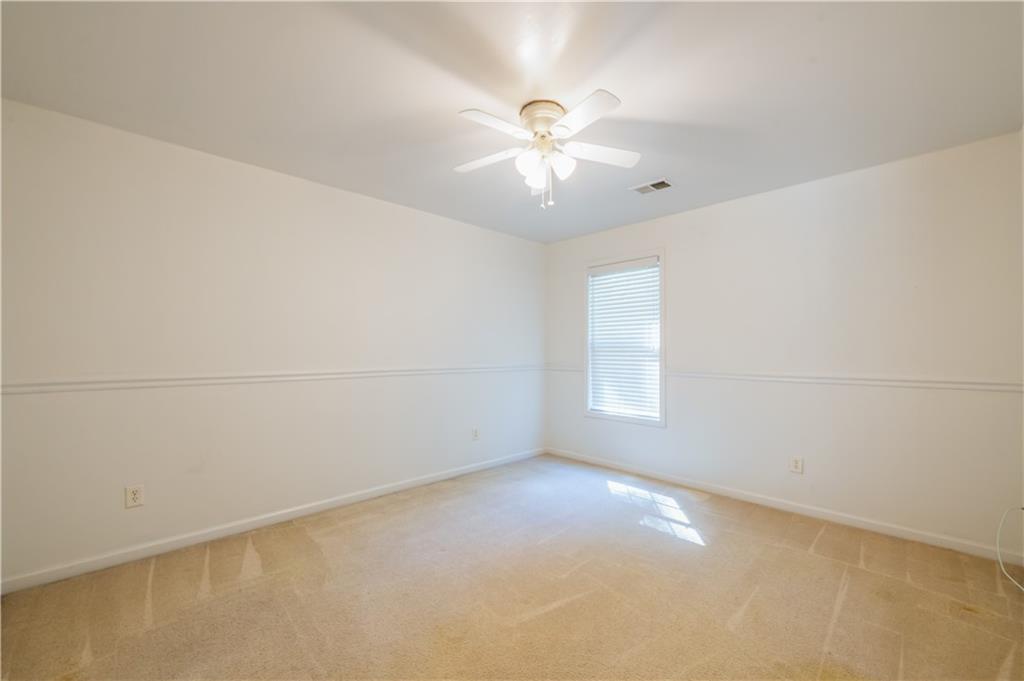 640 Fitzgerald Place Atlanta, GA 30349 - Photo 36 of 46 en empty room with windows and chandelier fan