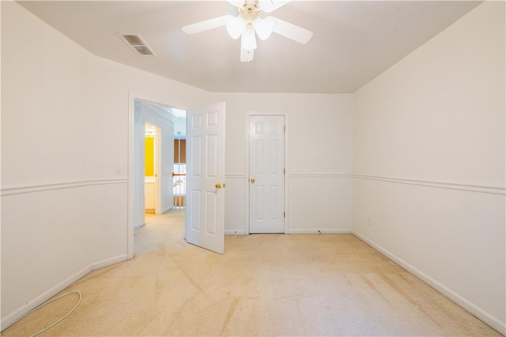 640 Fitzgerald Place Atlanta, GA 30349 - Photo 37 of 46 an empty room with a chandelier fan and windows