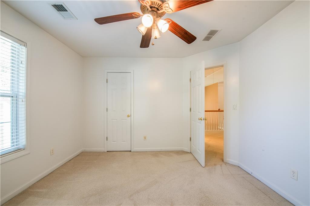 640 Fitzgerald Place Atlanta, GA 30349 - Photo 38 of 46 an empty room with closet and a chandelier fan