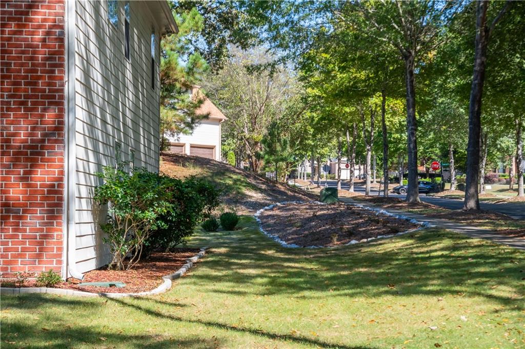640 Fitzgerald Place Atlanta, GA 30349 - Photo 39 of 46 a view of a backyard with plants and large trees
