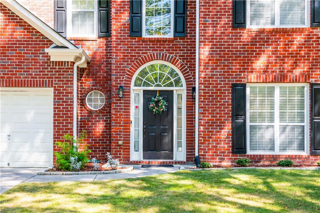 640 Fitzgerald Place Atlanta, GA 30349 - Photo 4 of 46 a front view of a house with a yard and outdoor seating