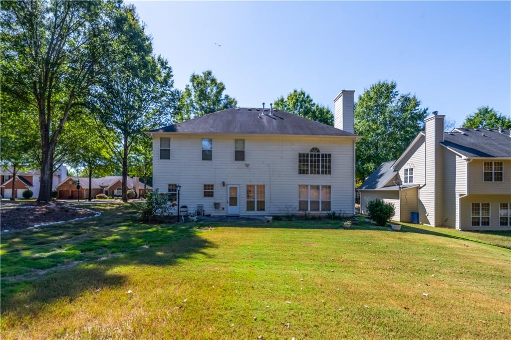 640 Fitzgerald Place Atlanta, GA 30349 - Photo 41 of 46 a view of a house with a yard patio and fire pit