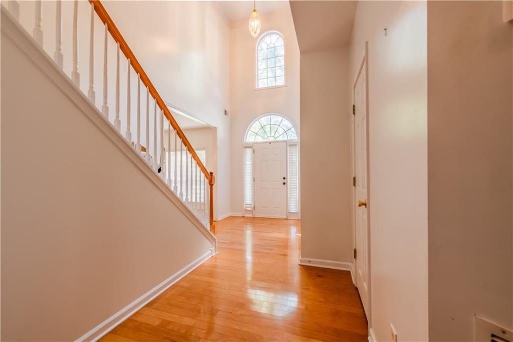 640 Fitzgerald Place Atlanta, GA 30349 - Photo 6 of 46 a view of a hallway with entryway wooden floor and stairs